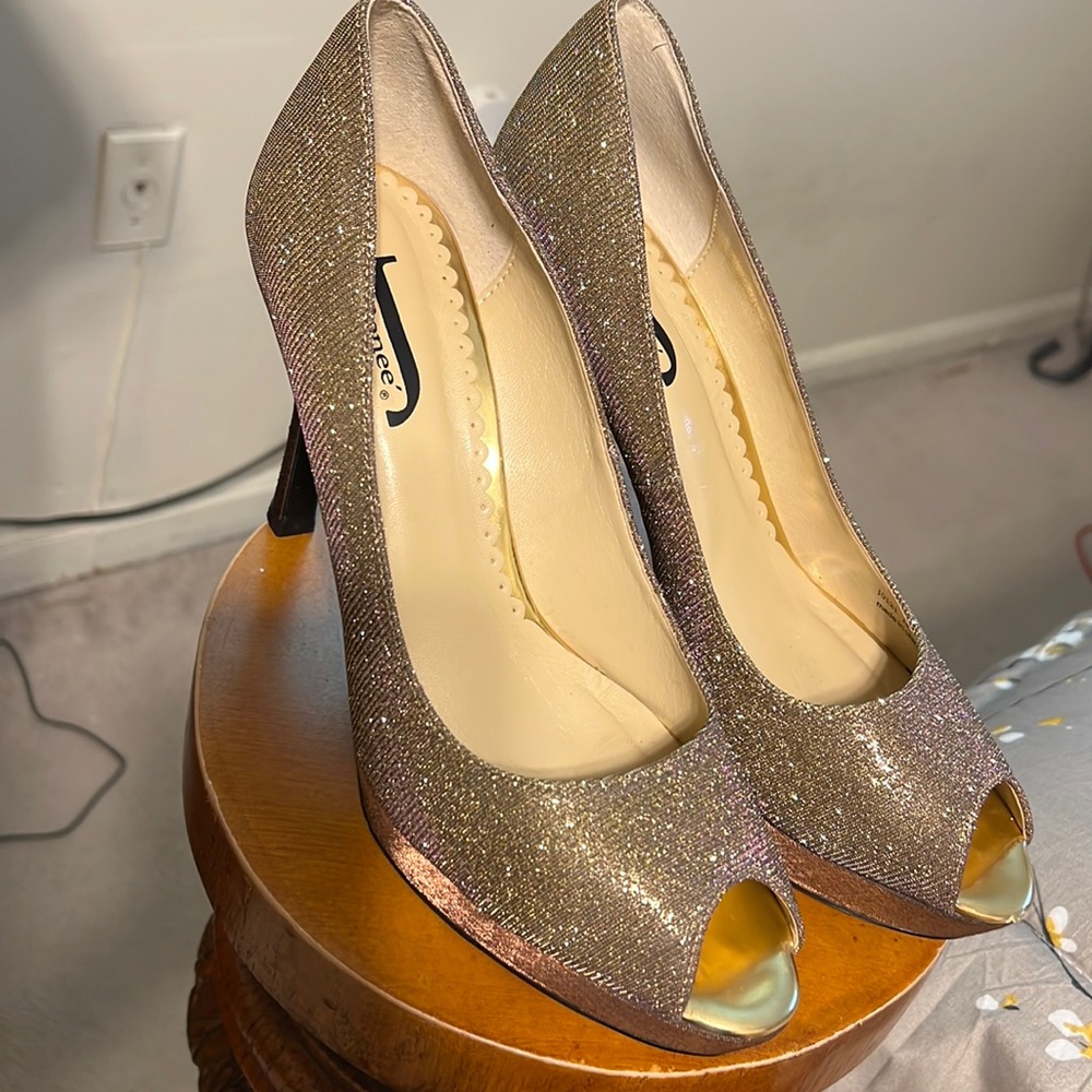 Open toe gold shoes with purple hue. High heeled shoes.